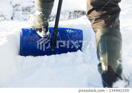 Clearing snow with a shovel Clearing snow with a shovel 134942209