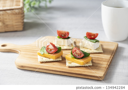 Cheese topping on crackers 134942284