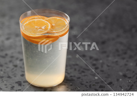 organic lemonade in tumbler glass on concrete background with copy space organic lemonade in tumbler glass on concrete background with copy space 134942724