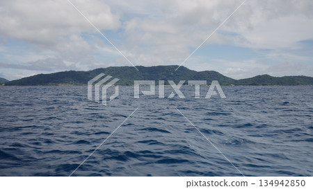 Side view from boat in Indian ocean sailing between Seychelles islands in daytime Side view from boat in Indian ocean sailing between Seychelles islands in daytime 134942850