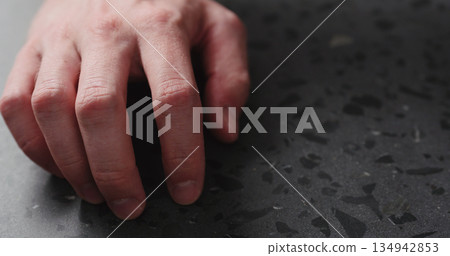 closeup man finger tapping on terrazzo countertop 134942853