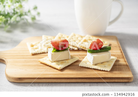 Cheese topping on crackers 134942916