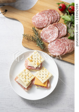 Cheese and salami sausage sandwich on crackers Cheese and salami sausage sandwich on crackers 134942984