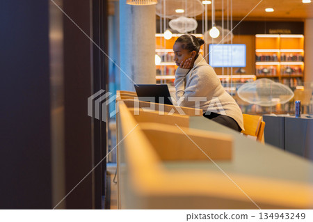 Student studying in a modern library Student studying in a modern library 134943249