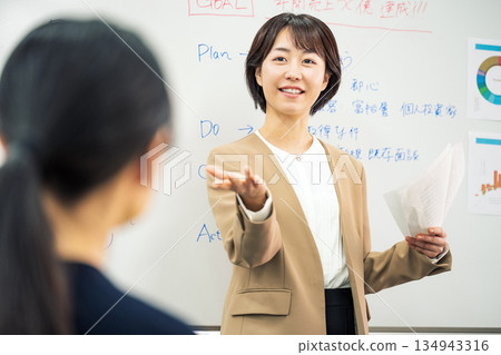 Young woman giving a presentation at a meeting Young woman giving a presentation at a meeting 134943316