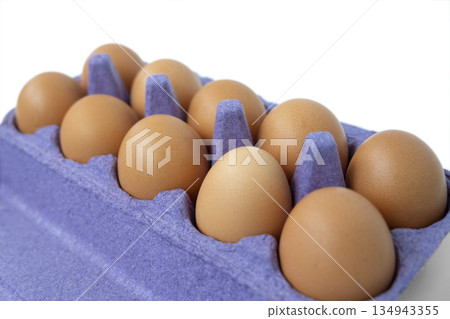 Brown chicken eggs in violet carton. Very peri trendy color of 2022 year 134943355