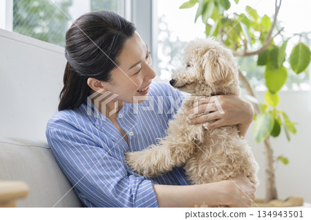 Middle-aged woman with her pet dog 134943501