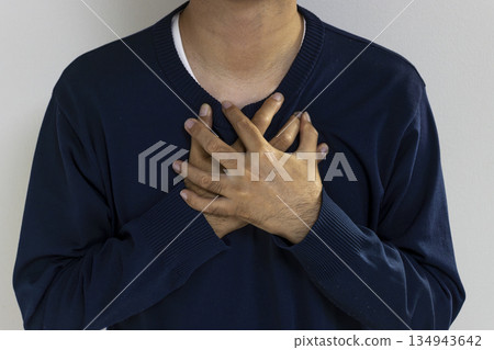 A man holding his chest. Image of illness (Japanese, faceless, 30s) A man holding his chest. Image of illness (Japanese, faceless, 30s) 134943642