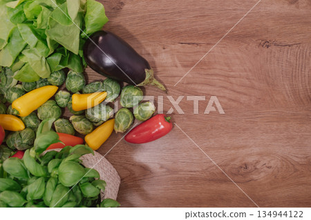 Fresh, colorful vegetables and greens on a wooden background with copy space Fresh, colorful vegetables and greens on a wooden background with copy space 134944122