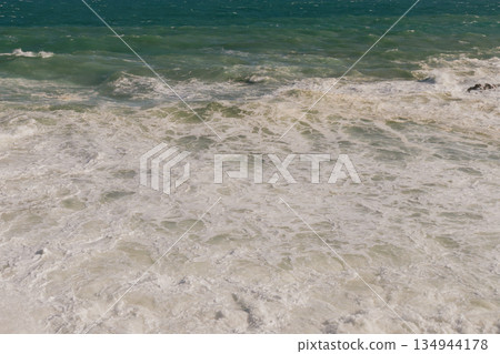 Natural marine background of stormy sea surface, powerful waves and white foam. Natural marine background of stormy sea surface, powerful waves and white foam. 134944178
