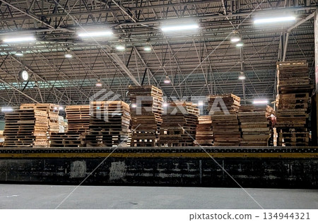 Pallets piled up at a truck terminal. Wooden pallets. 134944321