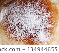 Powdered sugar pastry bun. Close up dessert. 134944655