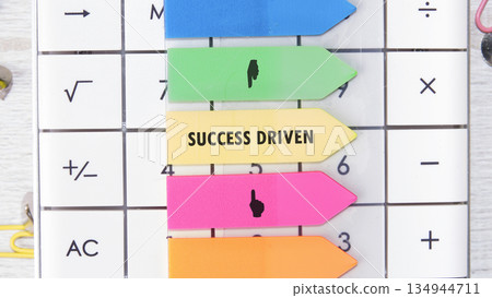 Calculator features vibrant index tabs showing concepts yellow tab says SUCCESS DRIVEN, and some have simple hand gestures emphasizing direction Calculator features vibrant index tabs showing concepts yellow tab says SUCCESS DRIVEN, and some have simple hand gestures emphasizing direction 134944711