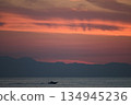 A ship leaving port at dawn 134945236