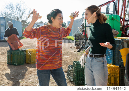 Women agriculturists having emotional conversation outdoors Women agriculturists having emotional conversation outdoors 134945642