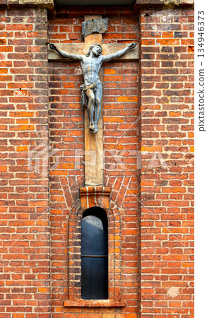 Jesus christ crucifix sculpture on old brick wall 134946373