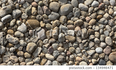 Natural river rocks forming a textured stone pattern Natural river rocks forming a textured stone pattern 134946471