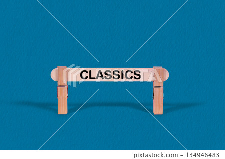 Classics symbol. Single Wooden stick confined by  Clothespins, Cool Blue Background. Business and Classics concept with copy space 134946483