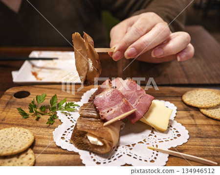 A blissful bite: hands picking up smoked daikon radish cheese A blissful bite: hands picking up smoked daikon radish cheese 134946512