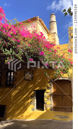 Old building facade with vibrant bougainvillea flowers Old building facade with vibrant bougainvillea flowers 134946584