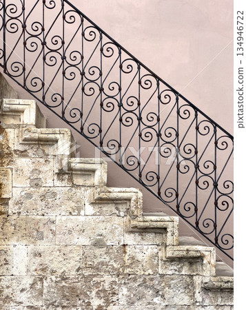 Ancient stone staircase with wrought iron railing detail Ancient stone staircase with wrought iron railing detail 134946722