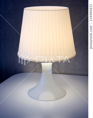 White table lamp illuminating a modern interior design 134946815