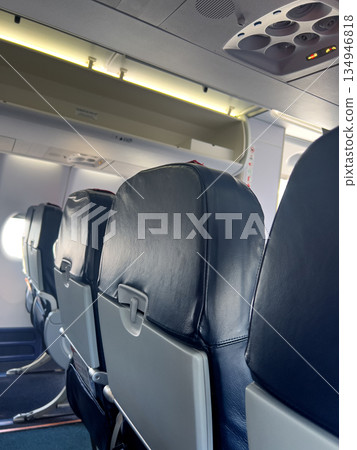 Airplane cabin interior with empty passenger seats Airplane cabin interior with empty passenger seats 134946818