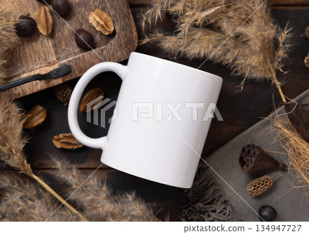 White blank coffee mug mockup on brown wood near pampas grass and natural decor elements White blank coffee mug mockup on brown wood near pampas grass and natural decor elements 134947727