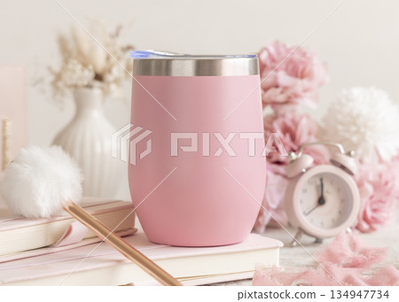 Pink blank 12oz wine tumbler near pink decor and flowers, pastel spring valentines mockup, closeup Pink blank 12oz wine tumbler near pink decor and flowers, pastel spring valentines mockup, closeup 134947734