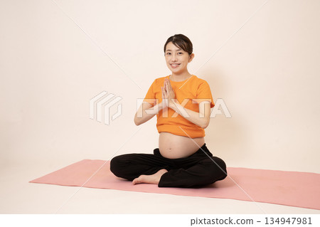 A woman doing maternity yoga A woman doing maternity yoga 134947981