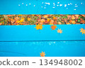 Blue bench and maple leaves 134948002
