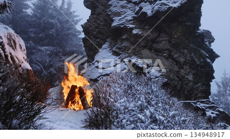 Crackling Campfire in the Winter Foggy Rocky Mountains , Harsh Atmosphere , Authentic Place 134948917