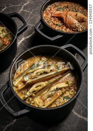 Portuguese traditional food fish soup and seafood risotto meal on restaurant table in lisbon Portuguese traditional food fish soup and seafood risotto meal on restaurant table in lisbon 134948937