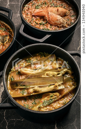 Portuguese traditional food fish soup and seafood risotto meal on restaurant table in lisbon Portuguese traditional food fish soup and seafood risotto meal on restaurant table in lisbon 134948940