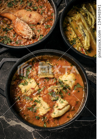 Portuguese traditional food fish soup and seafood risotto meal on restaurant table in lisbon Portuguese traditional food fish soup and seafood risotto meal on restaurant table in lisbon 134948941