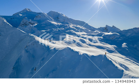 Panorama view of a snow-covered high mountains in Austria Alps with ski mountaineer 134948943