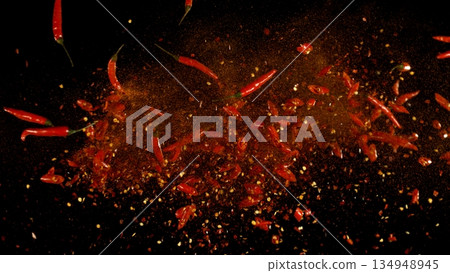 Freeze Motion Shot of Flying Red Chili Peppers Isolated on Black Background 134948945