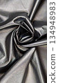 Black leather texture with soft folds and glossy surface 134948983