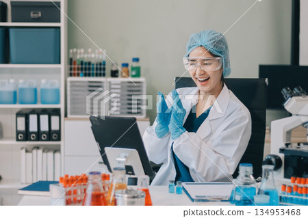 Portrait, science and happy woman on laptop in lab to research chemistry, test or innovation. Microscope, scientist and face of medical doctor in goggles for microbiology, healthcare or pharma study 134953468