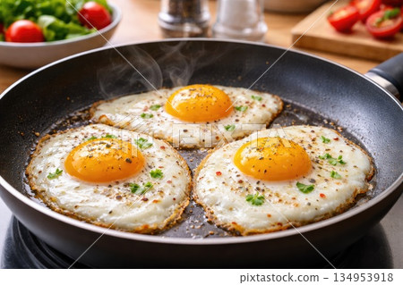 Fried Eggs Cooking in Pan for Breakfast 134953918