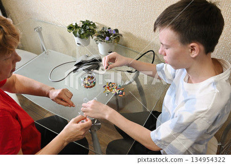 Boy listening to grandfather's heartbeat with stethoscope Boy listening to grandfather's heartbeat with stethoscope 134954322