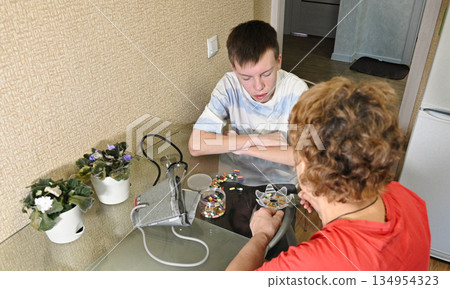 Boy listening to grandfather's heartbeat with stethoscope Boy listening to grandfather's heartbeat with stethoscope 134954323