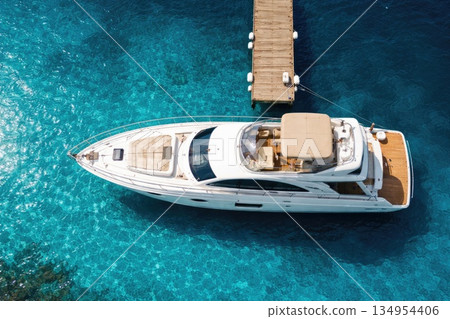 Luxury Motor Yacht Moored at Wooden Pier in Crystal Clear Blue Sea Aerial View Luxury Motor Yacht Moored at Wooden Pier in Crystal Clear Blue Sea Aerial View 134954406