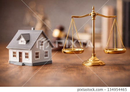 Real Estate Law Concept with House Model and Golden Justice Scales on Wooden Desk Real Estate Law Concept with House Model and Golden Justice Scales on Wooden Desk 134954465