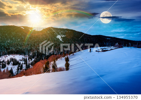beautiful winter landscape with snow covered hills. day and night time change concept. serene rural scene in mountains with sun and moon. rolling countryside area. duality and transition template 134955370
