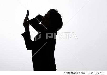 Silhouette of a worried woman Silhouette of a worried woman 134955715