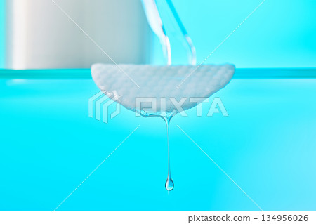 Cotton pad dropping liquid showing skincare purity and beauty 134956026
