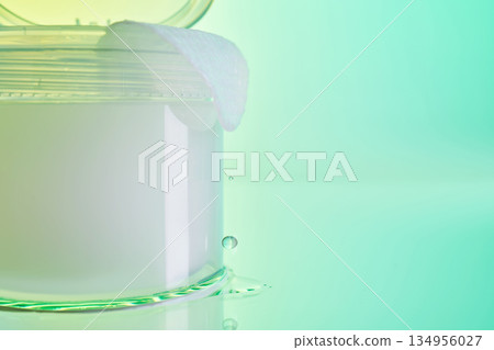 Cosmetic jar with facial pads and water drops 134956027