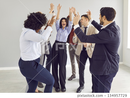 Multinational Office Team Celebrating Success with Group Dance 134957729