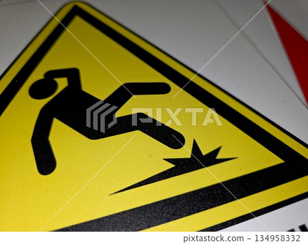Warning Sign About Falling Hazards in a Public Area Near a Construction Site During Daytime 134958332